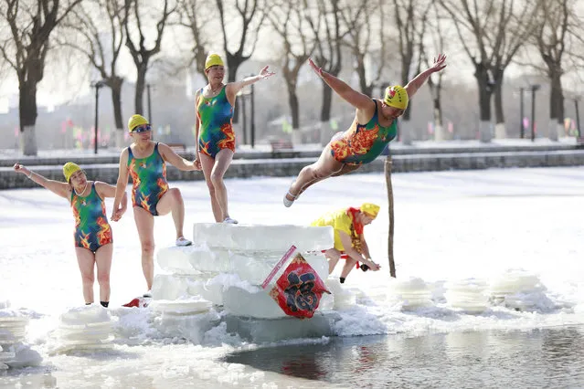 A woman dives into a partly frozen lake in Shenyang in China's northeastern Liaoning province on March 2, 2018. (Photo by AFP Photo/Stringer)