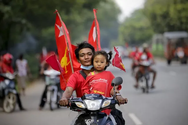 A supporter of the National League for Democracy (NLD) party rides a motorbike with a young girl during a campaign rally at Hlegu township in Yangon, Myanmar, 25 October 2020. Thousands of NLD supporters from Yangon’s outskirt township gathered and showed their support to the country’s ruling party ahead of the upcoming general elections of 08 November. (Photo by Lynn Bo Bo/EPA/EFE)