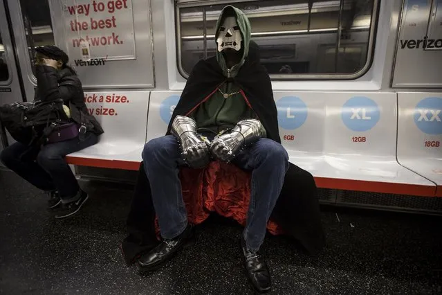 A man in costume rides the shuttle subway from Times Square to Grand Central Terminal in the Manhattan borough of New York November 1, 2015. (Photo by Carlo Allegri/Reuters)