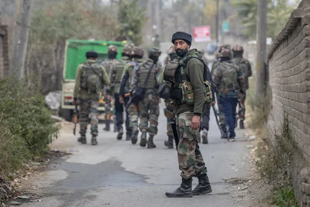 An Indian army soldier stands guard near the site of a gun battle on the outskirts of Srinagar, Indian controlled Kashmir, Sunday, November 1, 2020. (Photo by Dar Yasin/AP Photo)
