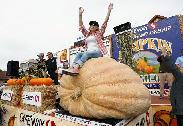 Cindy Tobeck sits atop her pumpkin after winning the Safeway World Championship Pumpkin Weigh-Off at Half Moon Bay, Calif., on Monday, October 10, 2016. Tobeck, of Olympia, Wash., won the contest with the pumpkin that weighed in at 1,910 pounds (866 kg). (Photo by Gary Reyes/BaySan Jose Mercury News via AP Photo)