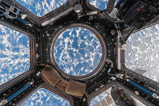 Cupola module, International Space Station, 2017. A stunning pattern of clouds and light over the ocean. The organic shapes of the clouds contrast with the geometric lines and shapes of the Cupola’s interior. (Photo by Paolo Nespoli and Roland Miller/The Guardian)