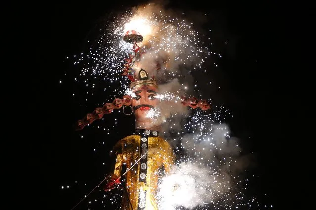 An effigy of demon king Ravana burns during Dussehra festivities in Ahmadabad, India, October 11, 2016. (Photo by Ajit Solanki/AP Photo)