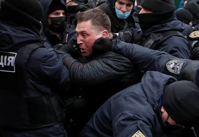 Ukrainian law enforcement officers restrain a demonstrator during a rally of entrepreneurs and representatives of small businesses amid the coronavirus disease (COVID-19) outbreak in Kyiv, Ukraine December 15, 2020. Entrepreneurs gathered to demand governmental support and to protest against restrictive measures introduced to curb the spread of the coronavirus. (Photo by Gleb Garanich/Reuters)