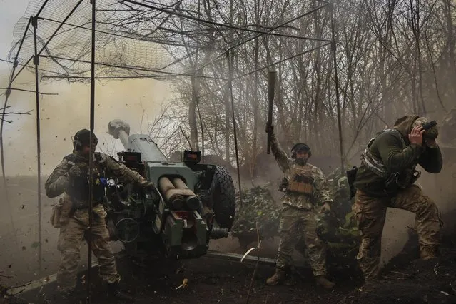 Ukrainian soldiers fire howitzer D-30 at the frontline near Bakhmut, Donetsk region, Ukraine, Wednesday, April 19, 2023. (Photo by Roman Chop via AP Photo)