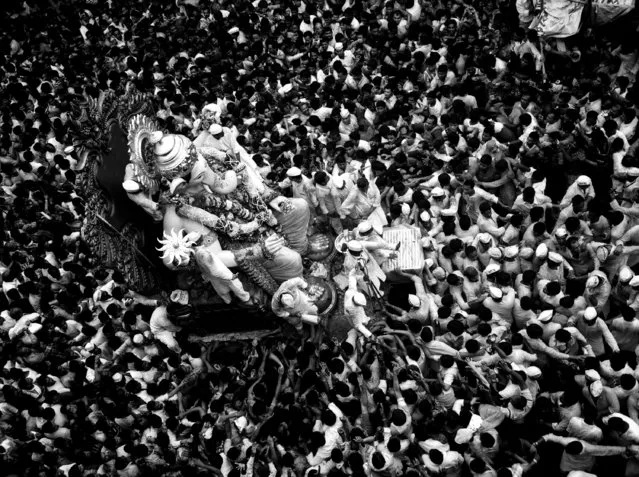 “Worship Frenzy”. It was the final day of Ganpati celebrations in 2011. Large processions of people took to the streets in celebration. Ganpati is one of the most worshiped Hindu deities. The average height of these idols is between 20 and 30 feet. Location: Mumbai, India. (Photo and caption by Girish Menon/National Geographic Traveler Photo Contest)