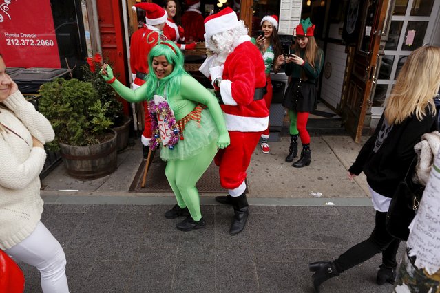 Revelers dressed in Santa Claus and other holiday themed outfits take part in the annual SantaCon event in the Brooklyn borough of New York, December 12, 2015. (Photo by Brendan McDermid/Reuters)