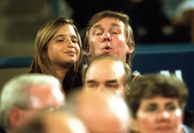 In this September 7, 1994 file photo, Donald Trump and his daughter Ivanka peek over the crowd as they take in a tennis match during the U.S. Open in New York. (Photo by Roh Frehm/AP Photo)