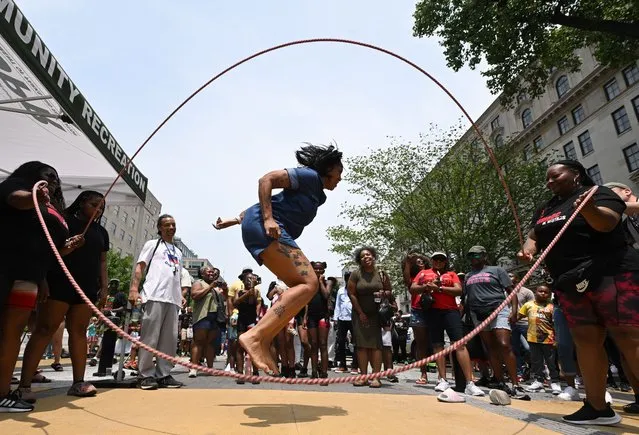 Pasua Turner jumps double dutch as people take part in a Juneteenth event along Black Lives Matter Plaza on Monday June 19, 2023 in Washington, DC. (Photo by Matt McClain/The Washington Post)