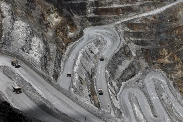 Trucks operate in the open-pit mine of PT Freeport's Grasberg copper and gold mine complex near Timika, in the eastern region of Papua, Indonesia, in this September 19, 2015 file photo taken by Antara Foto. (Photo by Muhammad Adimaja/Reuters/Antara Foto)