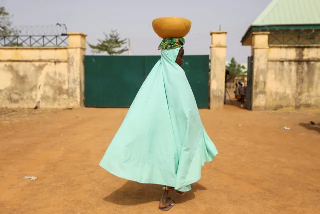 A milk maid walks toward the gate of JSS Jangebe school, a day after over 300 school girls were abducted from the school in Zamfara, Nigeria on February 27, 2021. (Photo by Afolabi Sotunde/Reuters)