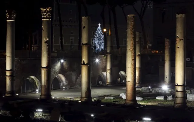 A Christmas tree is seen through ancient ruins in downtown Rome, Italy, December 10, 2015. (Photo by Stefano Rellandini/Reuters)