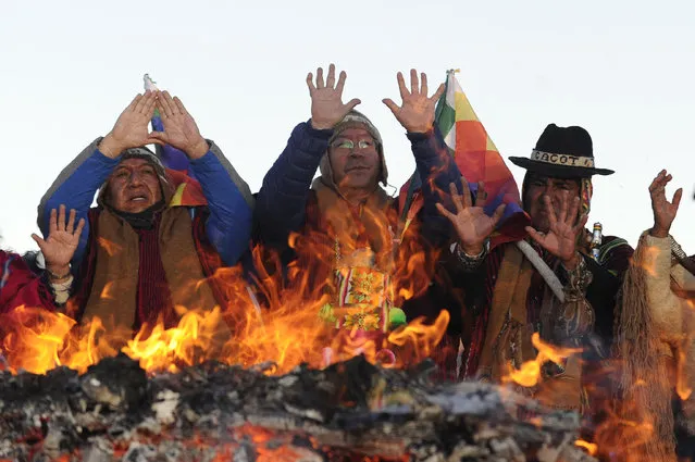 Bolivian President Luis Arce (C) and Vice-President David Choquehuanca (L) participate in the celebration of the winter solstice and the New Year of the Andean Indigenous people, which marks the beginning of the year 5531, at the archaeological site of Tiwanaku, about 70 km from La Paz, on June 21, 2023. (Photo by Jorge Bernal/AFP Photo)