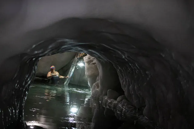 Ice swimmer Klaudia prepares to swim in a filled up water kettle in an ice cave inside the Nature Ice Palace, with a hight of 3,250 meters (10,663 feet) above sea level, at Hintertux Glacier near Hintertux, some 480 kilometers (298 miles) western of Vienna, Austria, 28 July 2018. (Photo by Christian Bruna/EPA/EFE)