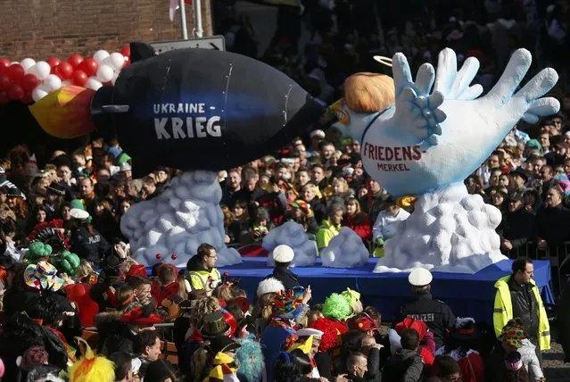 A carnival float with a papier-mache caricature drives past revellers during the traditional Rose Monday carnival parade in the western German city of Duesseldorf February 16, 2015. (Photo by Ina Fassbender/Reuters)
