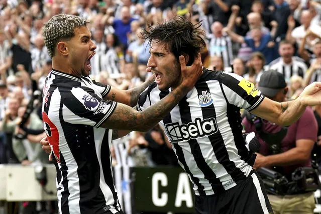 Newcastle United's Sandro Tonali, right, celebrates scoring their side's first goal of the game with Bruno Guimaraes during the Premier League soccer match between Newcastle United and Aston Villa at St. James' Park, Newcastle upon Tyne, England on Saturday, August 12, 2023. (Owen Humphreys/PA Wire via AP Photo)