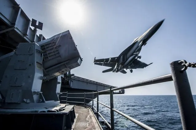 A U.S. Navy F/A-18 launches from the USS Carl Vinson in this undated handout picture released November 1, 2014.  U.S.-led air strikes hit Islamic State positions around Kobani earlier in the day in an apparent effort to pave the way for the heavily-armed Kurdish contingent to enter. (Photo by US Navy/Handout via Reuters)