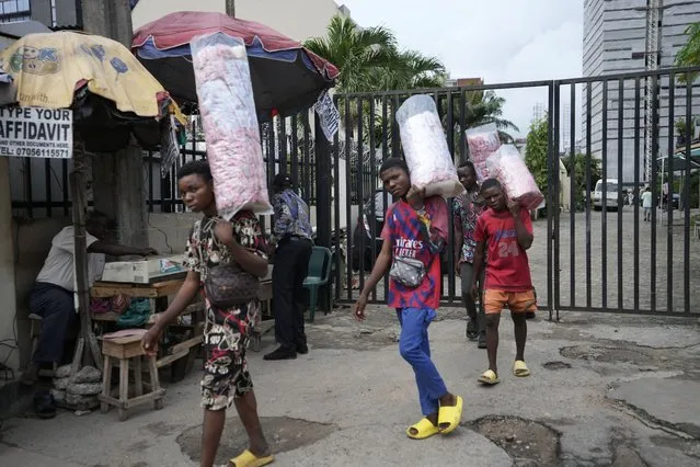 People sells snacks on the streets of Lagos, Nigeria, Tuesday September 5, 2023. (Photo by Sunday Alamba/AP Photo)