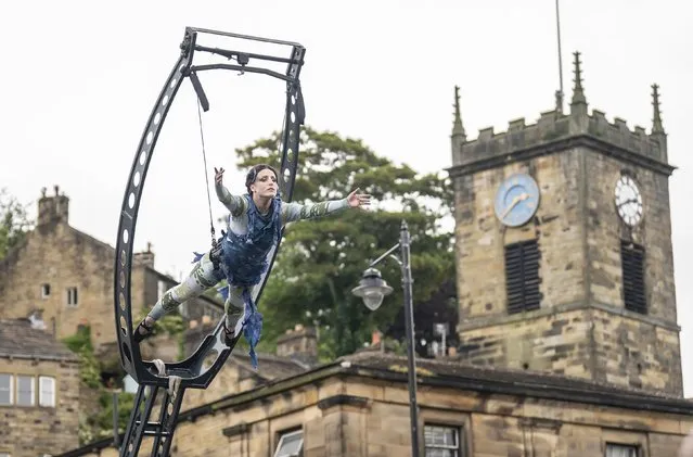 Emily Robertson performs in CastAway by Highly Sprung, during the Holmfirth Arts Festival in Town Gate, Holmfirth on Sunday, June 19, 2022. The stunning outdoor performance explores the impact of today's throwaway society on our waterways. (Photo by Danny Lawson/PA Images via Getty Images)