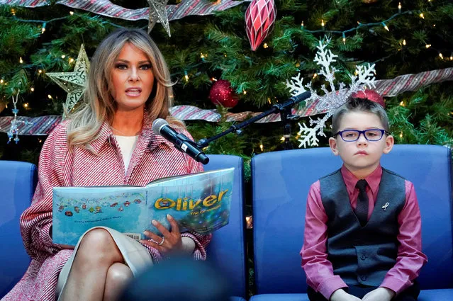 U.S. first lady Melania Trump sits beside Nathan Simm while reading a children's Christmas story during her visit to Children's National Health System in Washington, U.S., December 13, 2018. (Photo by Kevin Lamarque/Reuters)