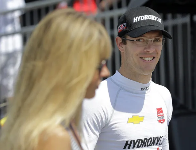 Sebastien Bourdais, of France, smiles as he walks to his car before practice for the IndyCar Firestone Grand Prix of St. Petersburg auto race Saturday, March 28, 2015, in St. Petersburg, Fla. The race takes place on Sunday. (Photo by Chris O'Meara/AP Photo)
