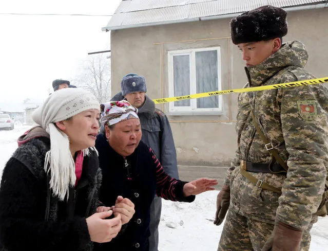 Relatives of people killed on the spot at the site of an airplane crash near the airport Manas, 30 kilometers from Bishkek, Kyrgyzstan, 16 January 2017. A Turkish Boeing 747-400 cargo plane crashed on a village near the capital of Kyrgyzstan, destroying 32 houses and killing at least 37 people, according to reports. (Photo by Igor Kovalenko/EPA)