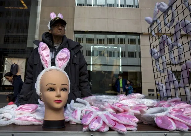 A man sells bunny ears at the Easter Parade and Bonnet Festival along 5th Avenue in New York City April 5, 2015. (Photo by Eric Thayer/Reuters)