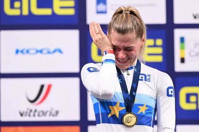First placed France's Clara Copponi reacts as she celebrates with her gold medal on the podium for the Women's Scratch race during the second day of the UEC European Track Cycling Championships at the Omnisport indoor arena in Apeldoorn, on January 11, 2024. (Photo by John Thys/AFP Photo)