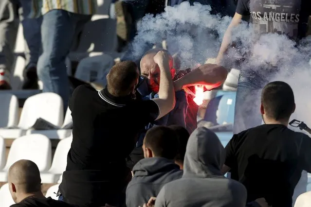 Red Star Belgrade and Partizan Belgrade fans clash in the stadium before the teams' Serbian Superliga soccer match in Belgrade, April 25, 2015. Serbian league leaders Partizan Belgrade held champions and bitter city foes Red Star to a 0-0 draw in a derby match marred by bad crowd trouble before kickoff on Saturday. (Photo by Marko Djurica/Reuters)