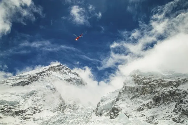A rescue helicopter is shown above the Mount Everest south base camp in Nepal a day after a huge earthquake-caused avalanche killed at least 17 people, in this photo courtesy of 6summitschallenge.com taken on April 26, 2015 and released on April 27, 2015. (Photo by Reuters/6summitschallenge.com)