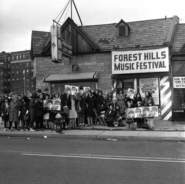 Teenaged girls, after waiting through the night at the Forest Hills Music Festival ticket office in New York, are still waiting on the sidewalk, on May 1, 1964, waiting for tickets to go on sale for concert scheduled by the Beatles in August. The ticket box was due to open at Eleven a.m. The mop-haired British singing group will be on their second visit to New York when they appear at the Forest Hills stadium. (Photo by AP Photo)