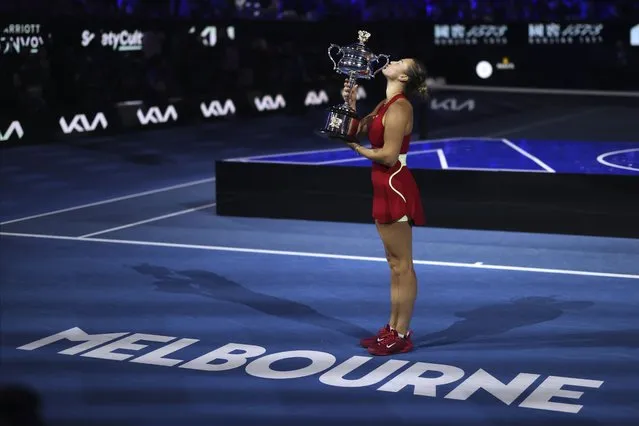 Aryna Sabalenka of Belarus kisses the Daphne Akhurst Memorial Cup after defeating Zheng Qinwen of China in the women's singles final at the Australian Open tennis championships at Melbourne Park, Melbourne, Australia, Saturday, January 27, 2024. (Photo by Asanka Brendon Ratnayake/AP Photo)