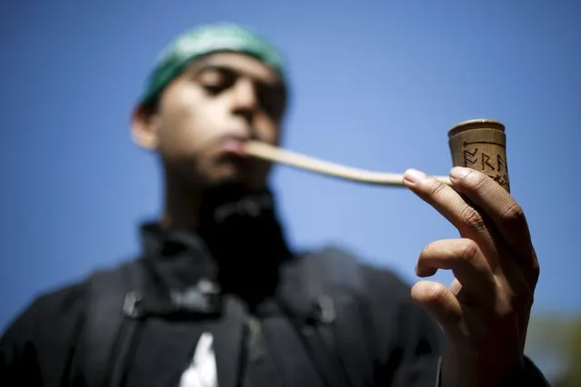 A man smokes marijuana in a pipe while people take part in a rally calling for marijuana to be  legalized at Union Square in New York May 2, 2015. (Photo by Eduardo Munoz/Reuters)