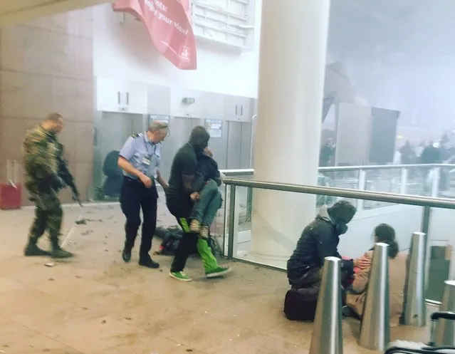 This photo provided by Georgian Public Broadcaster and photographed by Ketevan Kardava, shows the scene in Brussels Airport in Brussels, Belgium, after explosions were heard Tuesday, March 22, 2016. A developing situation left a number dead in explosions that ripped through the departure hall at Brussels airport Tuesday, police said. All flights were canceled, arriving planes were being diverted and Belgium's terror alert level was raised to maximum, officials said. (Photo by Ketevan Kardava/Georgian Public Broadcaster via AP Photo)
