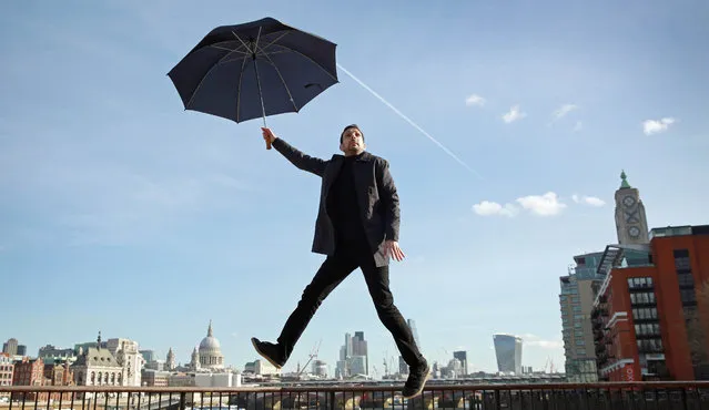 Magician Dynamo, real name Steven Frayne, creates a series of illusions including “floating above the London skyline using an umbrella”, for the launch of a new Samsung smartphone in London, UK on March 8, 2016. (Photo by Matt Alexander/PA Wire)
