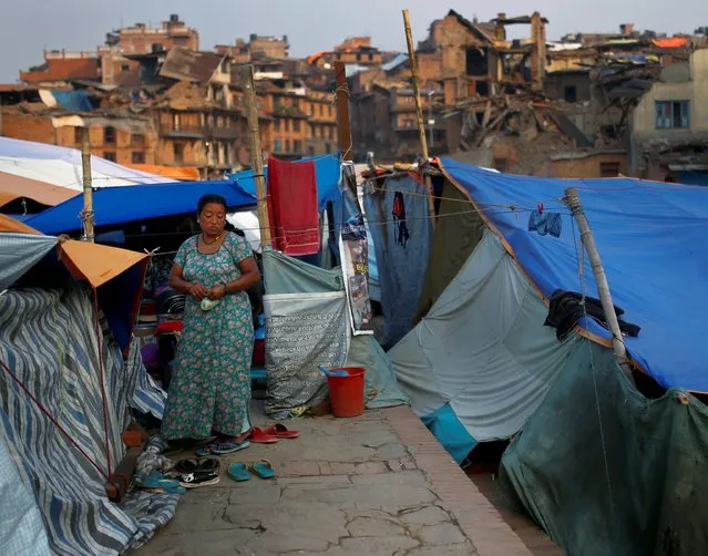 A woman stands next to tents set up after earthquakes, in  Bhaktapur, Nepal, May 18, 2015. (Photo by Ahmad Masood/Reuters)