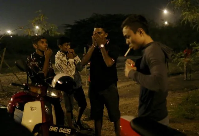 Motorcyclists react after their motorbikes were confiscated by police on a highway in Kuala Lumpur, Malaysia, September 14, 2014. (Photo by Olivia Harris/Reuters)