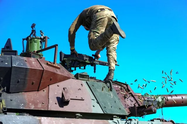 A service member of the 37th Marine Brigade of the Ukrainian Armed Forces removes empty cartridges from a French AMX-10 RC armoured fighting vehicle during military drills, amid Russia's attack on Ukraine, in an undisclosed location in Southern Ukraine on April 3, 2024. (Photo by Ivan Antypenko/Reuters)