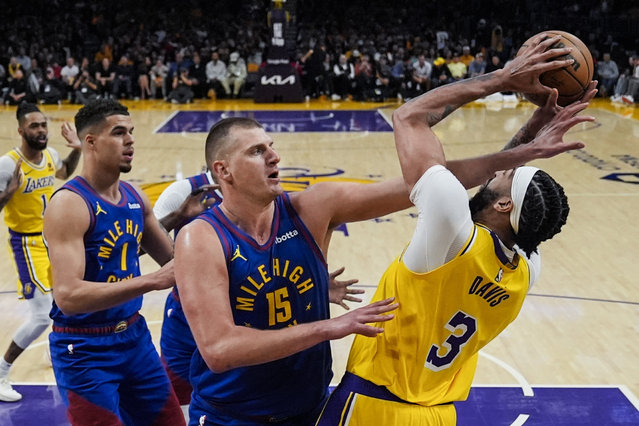 Denver Nuggets center Nikola Jokic (15) defends against Los Angeles Lakers forward Anthony Davis (3) during the first half of Game 3 of an NBA basketball first-round playoff series in Los Angeles, Thursday, April 25, 2024. (Photo by Ashley Landis/AP Photo)
