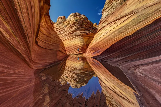 “Mirrow Wave ”. The Wave after a heavy thunderstorm with a small pond granting a perfect mirror for the reflection of the hiker. A calm and solemn place at a perfect day. Photo location: The Wave at the Vermillion Cliffs National Monument, Arizona/Utah. (Photo and caption by Nicholas Roemmelt/National Geographic Photo Contest)
