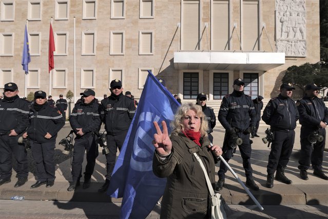 A protester gestures outside the Prime Minister's Office during an anti-government protest rally in Tirana, Albania, Saturday, February 11, 2023. Thousands of Albanian opposition supporters on Saturday held an anti-government protest accusing it of alleged corruption and economic poverty. (Photo by Franc Zhurda/AP Photo)