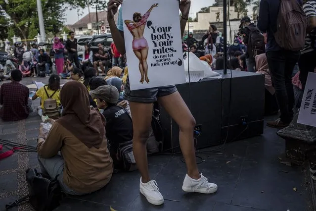 A woman holds a poster during celebrates International Women's Day on March 8, 2017 in Yogyakarta, Indonesia. International Women's Day was first marked in 1911 and celebrated each year on 08 March with thousands of events around the world by women's networks. (Photo by Ulet Ifansasti/Getty Images)