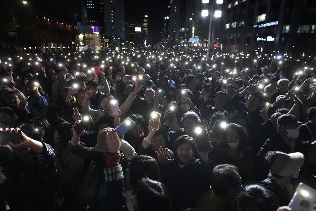 Supporters of South Korea's ruling People Power Party flash their smartphones' lights during the party's parliamentary election campaign in Seoul, South Korea, Tuesday, April 9, 2024. (Photo by Lee Jin-man/AP Photo)