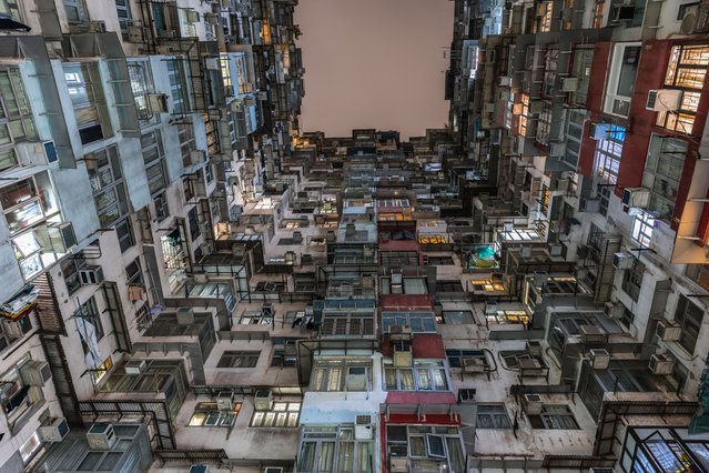 This picture taken on April 30, 2024 shows air conditioning units on an apartment building in Hong Kong. A record-breaking heatwave is broiling parts of Asia, helping drive surging demand for cooling options, including air-conditioning. AC exhaust units are a common feature of urban landscapes in many parts of Asia, clinging like limpets to towering apartment blocks in Hong Kong or tucked in a cross formation between the windows of a building in Cambodia. (Photo by Dale de la Rey/AFP Photo)