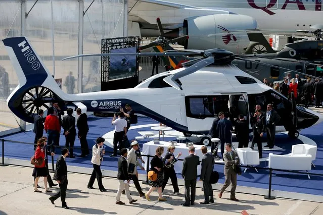 Visitors look at A H160 of Airbus Helicopter on display during the 51st Paris Air Show at Le Bourget airport near Paris June 17, 2015. REUTERS/Pascal Rossignol 