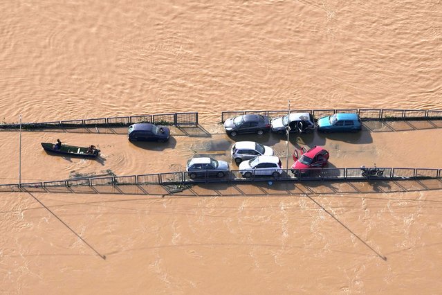 Cars sit on a submerged road in an area flooded by heavy rain in Porto Alegre, Rio Grande do Sul state, Brazil, Wednesday, May 8, 2024. (Photo by Andre Penner/AP Photo)