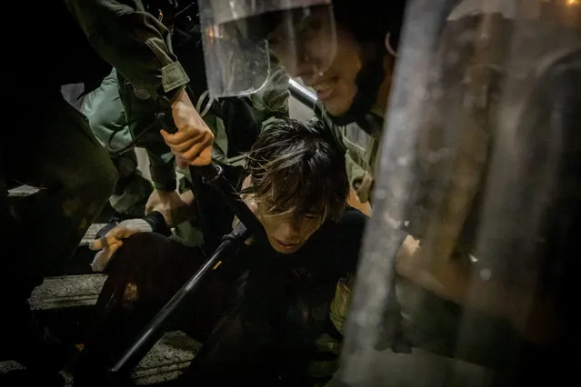 A protester is tackled by police during clashes after an anti-government rally in Tsuen Wan district on August 25, 2019 in Hong Kong, China. Pro-democracy protesters have continued rallies on the streets of Hong Kong against a controversial extradition bill since 9 June as the city plunged into crisis after waves of demonstrations and several violent clashes. Hong Kong's Chief Executive Carrie Lam apologized for introducing the bill and declared it “dead”, however protesters have continued to draw large crowds with demands for Lam's resignation and complete withdrawal of the bill. (Photo by Chris McGrath/Getty Images)