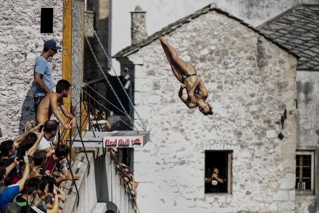 In this handout image provided by Red Bull, Jacqueline Valente of Brazil dives from the 21 metre platform on Stari Most during the first training session of the sixth stop of the Red Bull Cliff Diving World Series on August 22, 2019 at Mostar, Bosnia and Herzegovina. (Photo by Dean Treml/Red Bull via Getty Images)