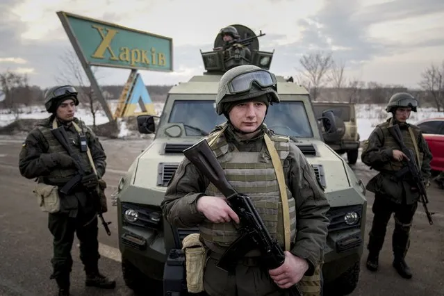 Ukrainian National guard soldiers guard the mobile checkpoint toghether with the Ukrainian Security Service agents and police officers during a joint operation in Kharkiv, Ukraine, Thursday, February 17, 2022. Fears of a new war in Europe have resurged as U.S. President Joe Biden warned that Russia could invade Ukraine within days, and violence spiked in a long-running standoff in eastern Ukraine that some fear could be the spark for wider conflict. (Photo by Evgeniy Maloletka/AP Photo)