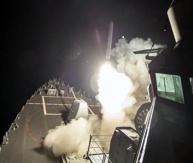 In this image provided by the U.S. Navy, the USS Ross (DDG 71) fires a tomahawk land attack missile Friday, April 7, 2017, from the Mediterranean Sea. The United States blasted a Syrian air base with a barrage of cruise missiles in fiery retaliation for this week's gruesome chemical weapons attack against civilians. (Photo by Mass Communication Specialist 3rd Class Robert S. Price/U.S. Navy via AP Photo)